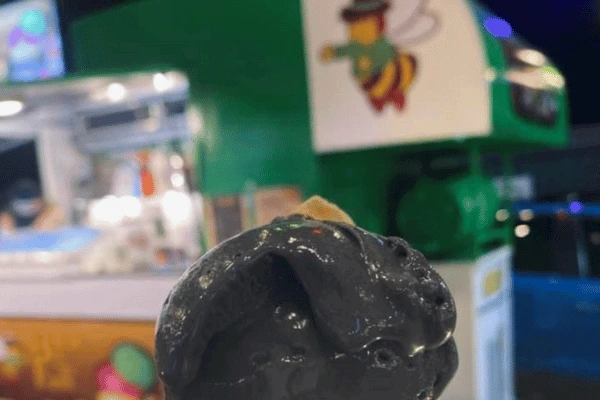 chocolate ice cream with a drawing of a bee in the background