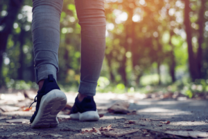 a pair of legs wearing a sports jeans and a pair of rubber shoes