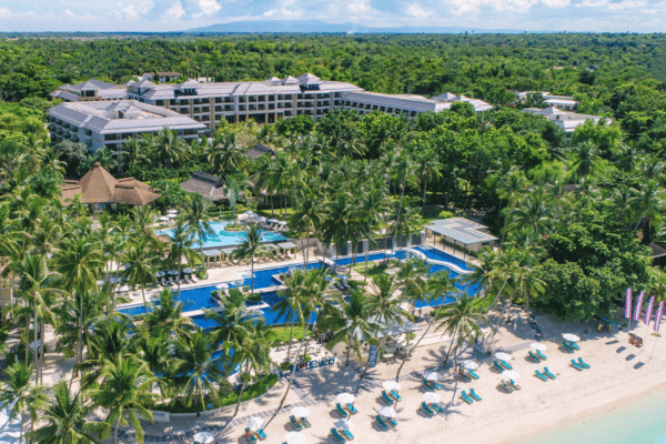 aerial view of henann resort alona beach showing the hotel, the resort, and the beachfront with a lot of palm trees and beach lounges