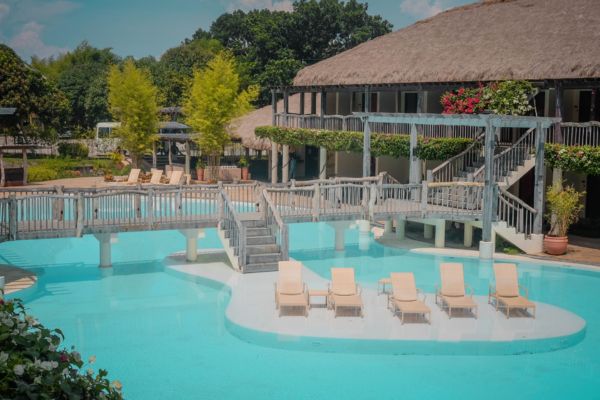 pool lounges in the middle of the swimmig pool on a platform connected by a footbridge from the hotel
