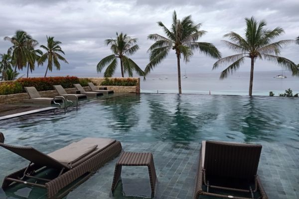 lounges infront of an infinity pool with the view of the ocean