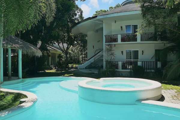 a pool with a view of the hotel