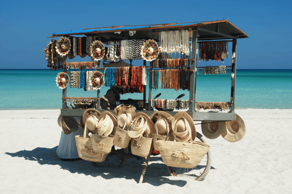 souvenir shop right with straw hats and other accessories right on the white sand beach