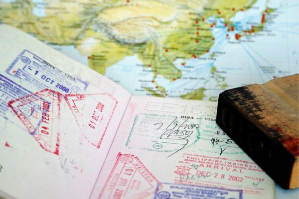 a passport with visa stamps and a map