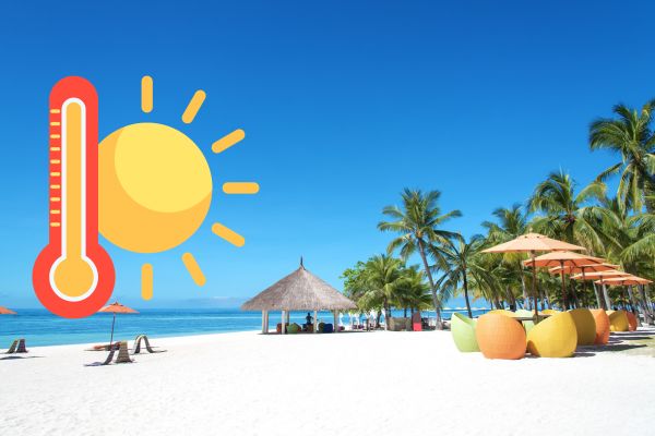 theremometer turning red with the sun right beside it looking at the beach on a clear day