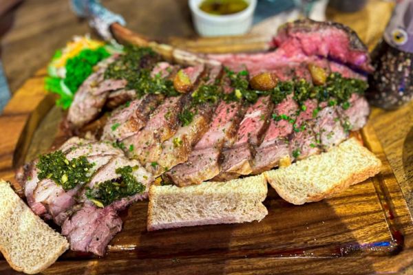 medium rate steak with bread and some herbs