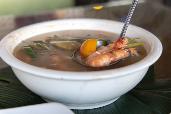 bowl of soup with shrimp in a white bowl