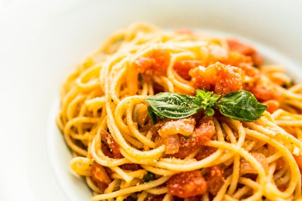 pasta with tomatoes and vegetable garnishing
