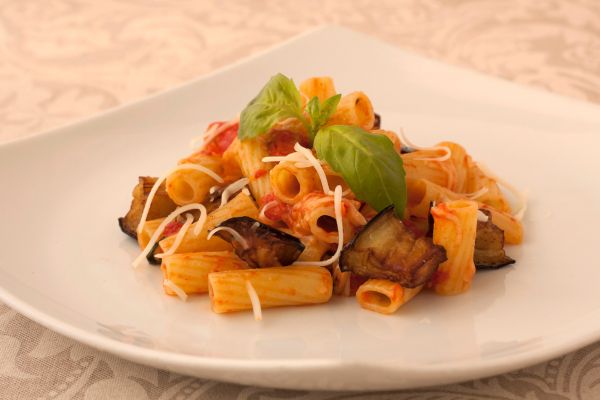 sicilian pasta with tomatoes, mushrooms and vegetable garnishing