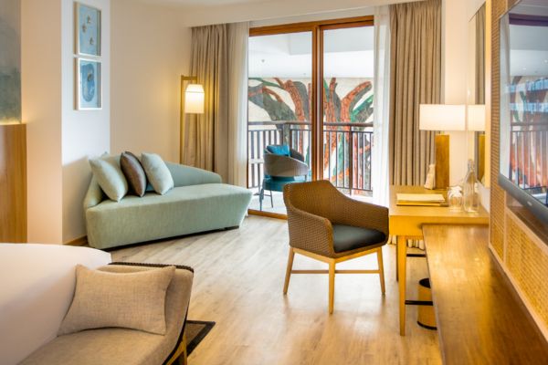 hotel room with a modern interior design, bright with open window and modern sofas and chairs