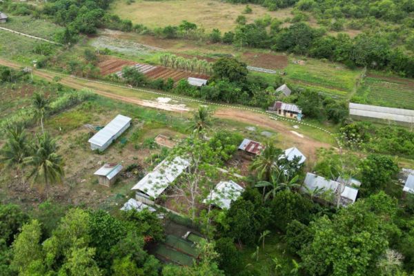 overhead view of an integrated organic farm with visible warehouses and farm sections and beddings